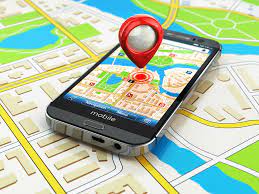 Smartphone displaying GPS map with a 3D red pin hovering over the screen